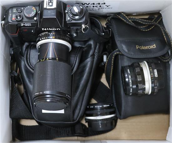 A Nikon F.301 camera, with Nikon SB-18 flash gun, a 70-120mm telescopic lens, one other lens and a Polaroid camera